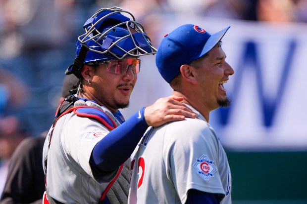 Chicago Cubs catcher Miguel Amaya, left, and pitcher Javier Assad celebrate after their win over the Kansas City Royals, Sunday, Aug. 9, 2026, in Kansas City, Mo. (AP Photo/Charlie Riedel)