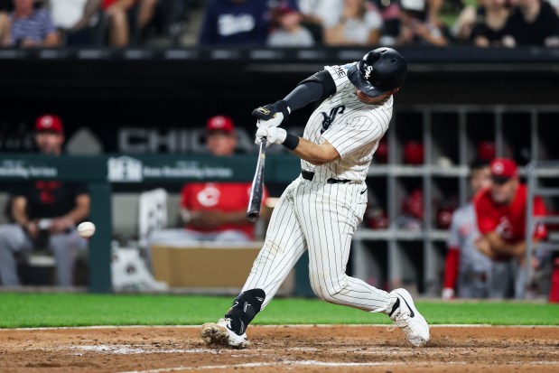 White Sox catcher Drew Romo hits an RBI single in the eighth inning against the Reds on Aug. 12, 2026, at Rate Field. (Armando L. Sanchez/Chicago Tribune)