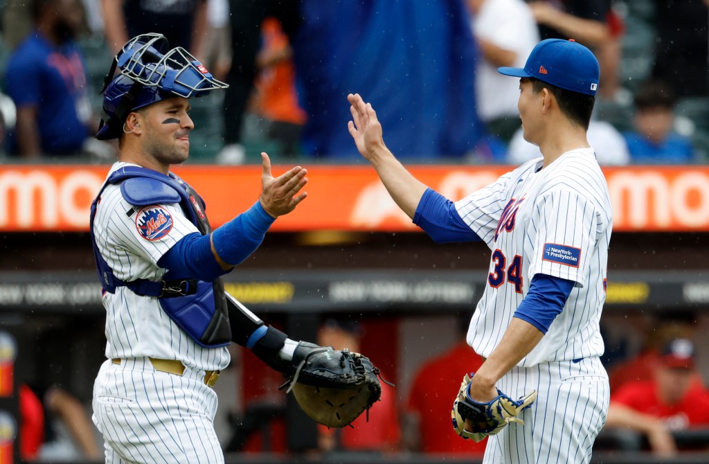 New York Mets catcher Luis Torrens and pitcher Kodai Senga high-five after defeating the Washington Nationals.