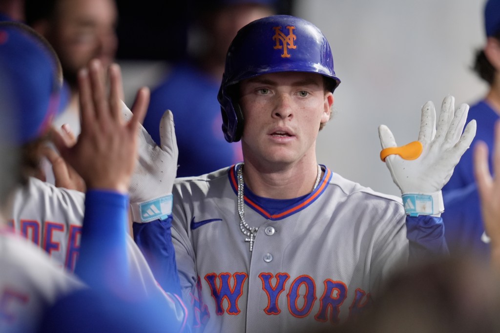 New York Mets' Carson Benge being congratulated in the dugout after hitting a home run.