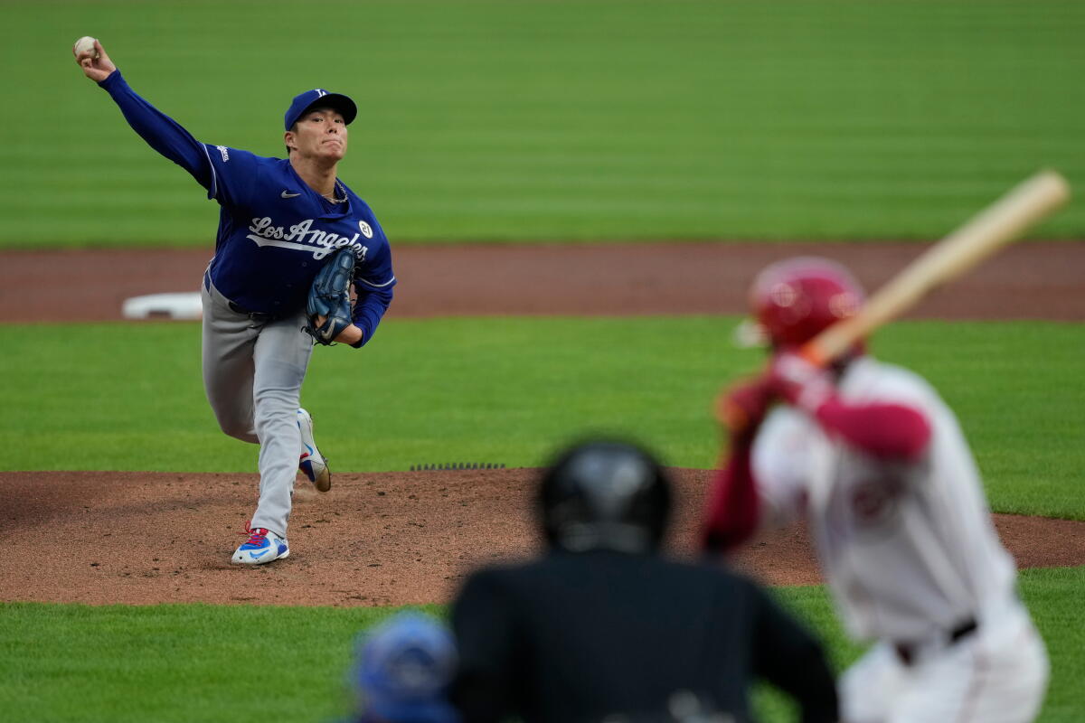 Yoshinobu Yamamoto pitches during one of his seven shutout innings against the Reds Tuesday.