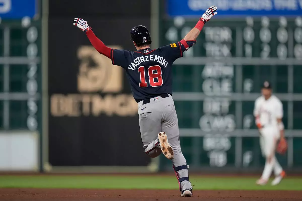 Atlanta Braves' Mike Yastrzemski celebrates after hitting a home run during the eighth inning of a baseball game against the Houston Astros in Houston, Saturday, Sept. 19, 2026. (AP Photo/Ashley Landis)