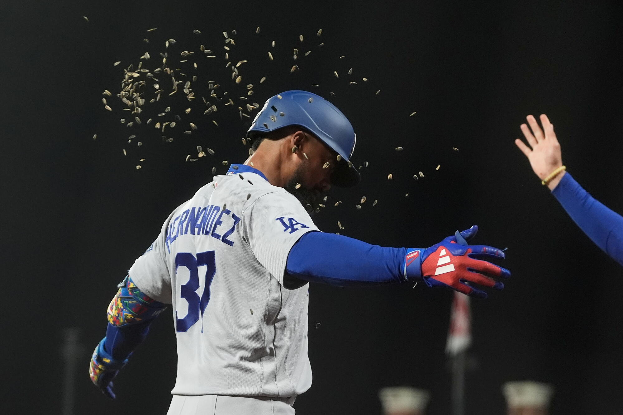 Teoscar Hernández is showered in sunflower seeds after hitting a home run against the Giants.
