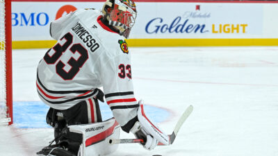 Sep 28, 2025; Saint Paul, Minnesota, USA; Chicago Blckkawks goalie Drew Commesso (33) collects a loose puck against the Minnesota Wild during the second period at Xcel Energy Center.