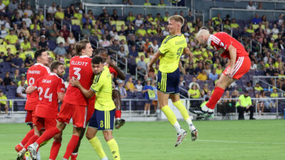 Sep 19, 2026; Nashville, Tennessee, USA; Nashville SC forward Sam Surridge (9) competes for a header with Chicago Fire defender Andrew Gutman (15) during the second half at Geodis Park.