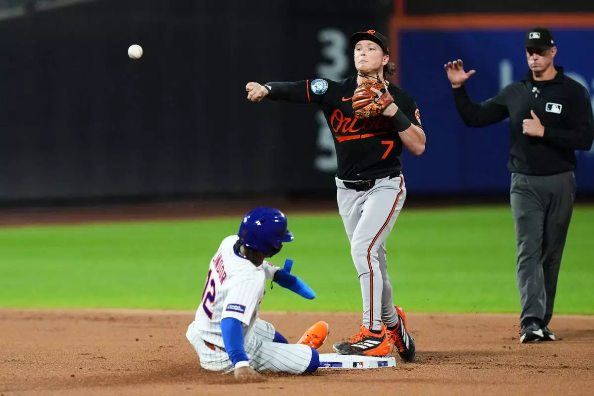 Baltimore Orioles' Jackson Holliday (7) throws out New York Mets' Bo Bichette at first base after foercing out Francisco Lindor (12) for a double play during the first inning of a baseball game Monday, Sept. 14, 2026, in New York. (AP Photo/Frank Franklin II)
