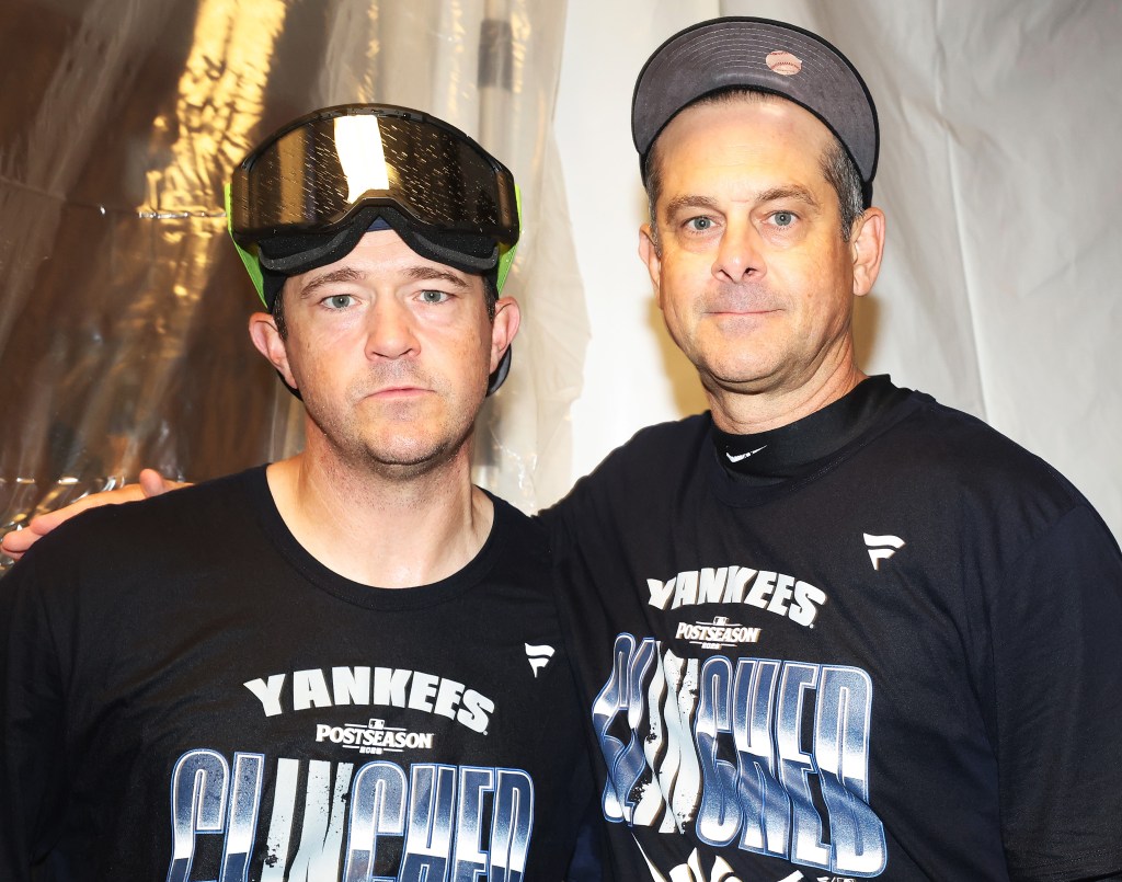 Aaron Boone (right) poses for a picture with pitching coach Matt Blake during the Yankees' postgame playoff clinching celebrations after their win over the Twins on Sept. 14, 2026.