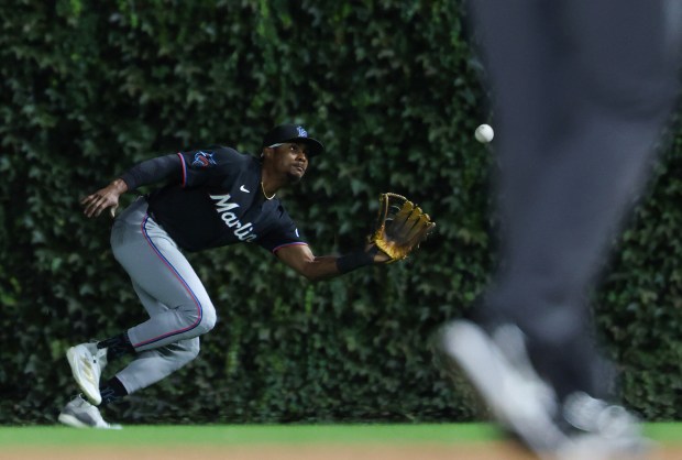 Marlins right fielder Esteury Ruiz reaches to catch a fly ball hit by Cubs designated hitter Matt Shaw to end the seventh inning at Wrigley Field on Sept. 22, 2026, in Chicago. (John J. Kim/Chicago Tribune)
