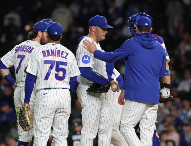 Cubs pitcher Caleb Thielbar, center, is taken out of the game in the 12th inning against the Marlins at Wrigley Field on Sept. 22, 2026, in Chicago. (John J. Kim/Chicago Tribune)