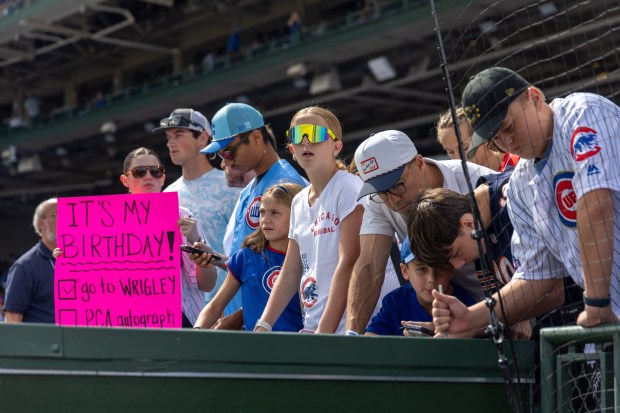Fans solicit autographs before a baseball game between the Pittsburgh Pirates and Chicago Cubs at Wrigley Field on Sunday, Sept. 13, 2026. (Arthur Maiorella/Chicago Tribune)