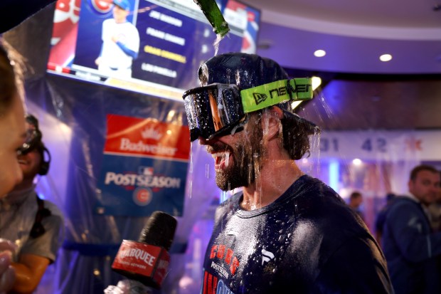 Dansby Swanson celebrates with teammates in the clubhouse after the Cubs clinched a playoff spot with a victory against the Marlins on Thursday, Sept. 24, 2026, at Wrigley Field. (Chris Sweda/Chicago Tribune)