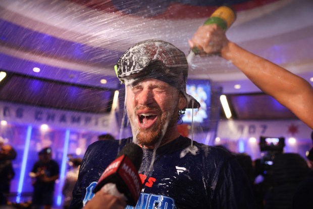 Dansby Swanson celebrates with teammates in the clubhouse after the Cubs clinched a playoff spot with a victory against the Marlins on Thursday, Sept. 24, 2026, at Wrigley Field. (Chris Sweda/Chicago Tribune)
