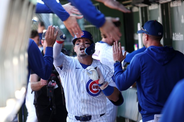 Cubs right fielder Seiya Suzuki high-fives teammates in the dugout after hitting a solo home run in the fifth inning against the Marlins on Thursday, Sept. 24, 2026, at Wrigley Field. (Chris Sweda/Chicago Tribune)