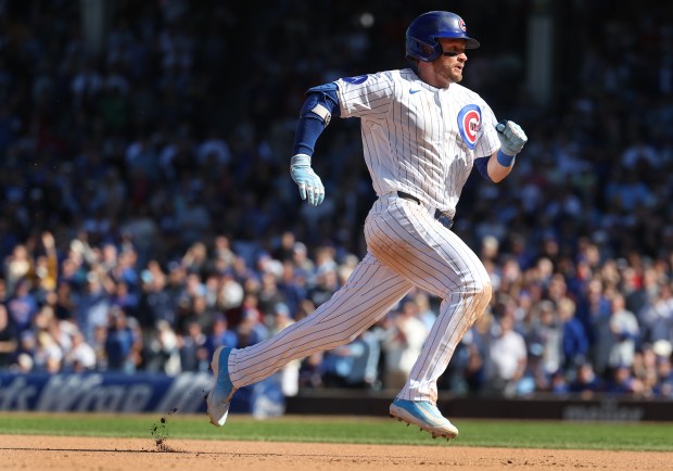 Cubs left fielder Ian Happ sprints to third base on a triple in the sixth inning against the Marlins on Thursday, Sept. 24, 2026, at Wrigley Field. (Chris Sweda/Chicago Tribune)