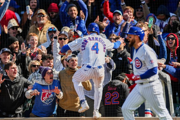 Cubs center fielder Pete Crow-Armstrong, 4, celebrates with fans after scoring off Cubs second baseman Nico Hoerner's walk-off sacrifice fly to give the Cubs a, 2-1, win over the Mets at Wrigley Field on April 19, 2026. (Armando L. Sanchez/Chicago Tribune)