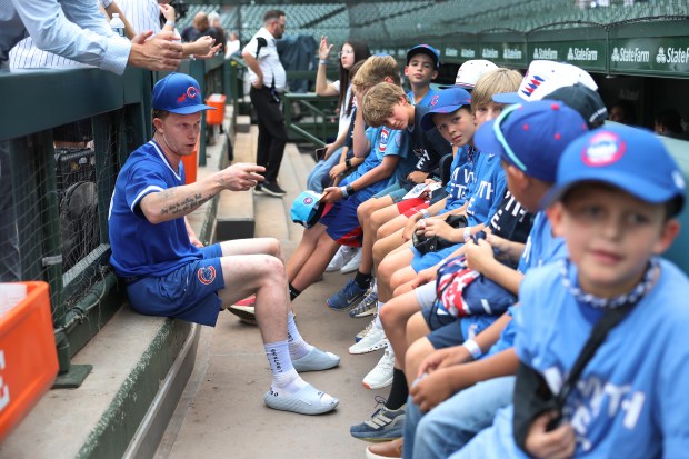 Cubs center fielder Pete Crow-Armstrong talks to a group of children in the dugout before a game against the Chicago White Sox at Wrigley Field on Aug. 18, 2026. (Chris Sweda/Chicago Tribune)