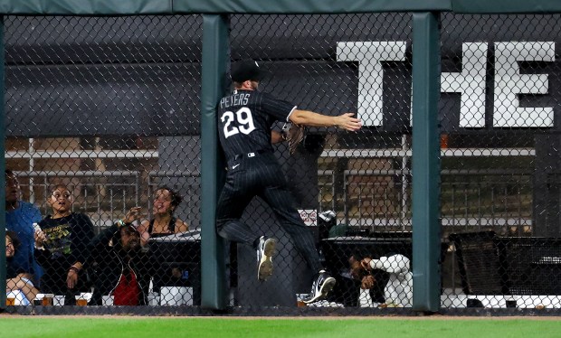 White Sox right fielder Tristan Peters suffers an injury as he crashes into the outfield wall on Tigers shortstop Kevin McGonigle's three-run triple in the fifth inning Sept. 18, 2026, at Rate Field. (Chris Sweda/Chicago Tribune)