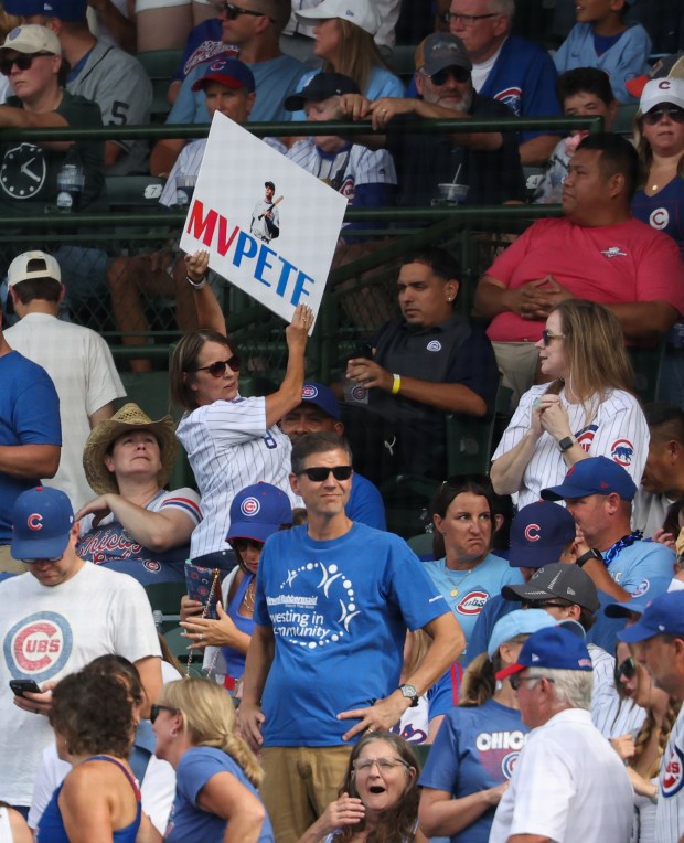 A fan holds up a sign in support of Cubs center fielder Pete Crow-Armstrong in the eighth inning against the Reds at Wrigley Field on Aug. 29, 2026. (John J. Kim/Chicago Tribune)