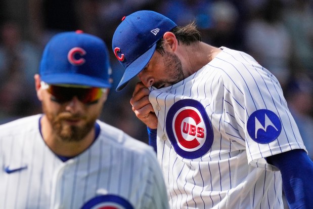 Cubs starter Clay Holmes, right, wipes his face during the sixth inning against the Pirates on Saturday, Sept. 12, 2026, at Wrigley Field. (Nam Y. Huh/AP)