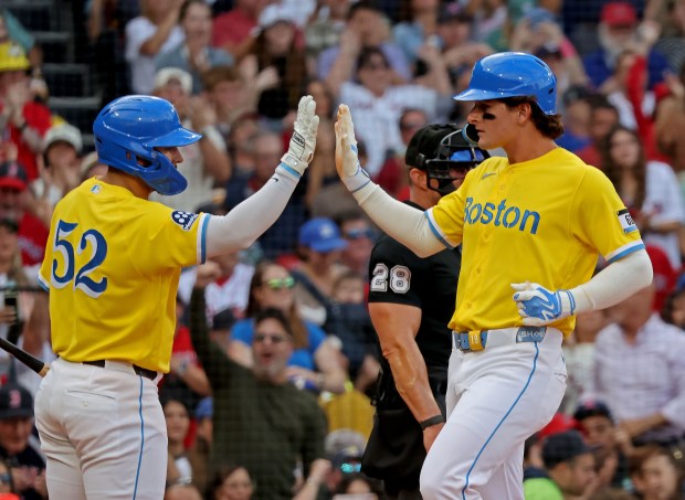 Boston Red Sox left fielder Roman Anthony, right, is congratulated on scoring by Boston Red Sox right fielder Wilyer Abreu on a drive by Boston Red Sox catcher Adley Rutschman in the fourth as the Red Sox take on the Royals. (Stuart Cahill/Boston Herald)