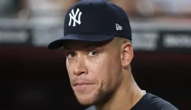 Aaron Judge #99 of the New York Yankees stands in the dugout during the fifth inning of the game against the Arizona Diamondbacks at Chase Field on September 18, 2026 in Phoenix, Arizona.