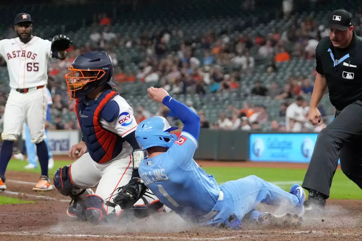 Kansas City Royals' Isaac Collins (1) scores as Houston Astros catcher Yainer Diaz reaches to tag him during the eighth inning of a baseball game Wednesday, Sept. 16, 2026, in Houston. (AP Photo/David J. Phillip)