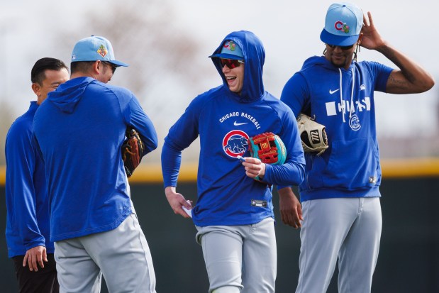 Seiya Suzuki, from left, Pete Crow-Armstrong and Kevin Alcántara laugh in the outfield while practicing during spring training at Sloan Park on Feb. 18, 2026, in Mesa, Arizona. (Armando L. Sanchez/Chicago Tribune)