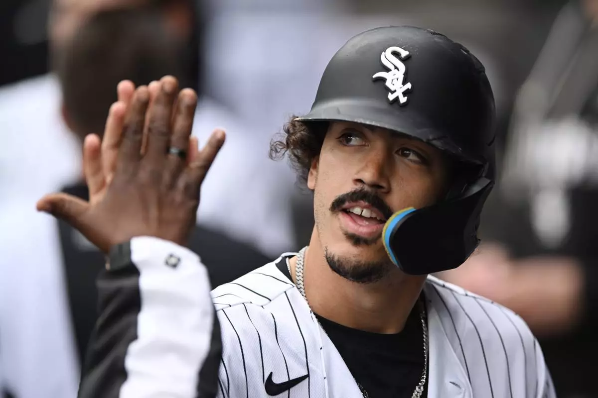 Chicago White Sox's Miguel Vargas celebrates with teammates in the dugout after scoring on a Munetaka Murakami single during the first inning of a baseball game against the Detroit Tigers Saturday, Sept. 19, 2026, in Chicago. (AP Photo/Paul Beaty)