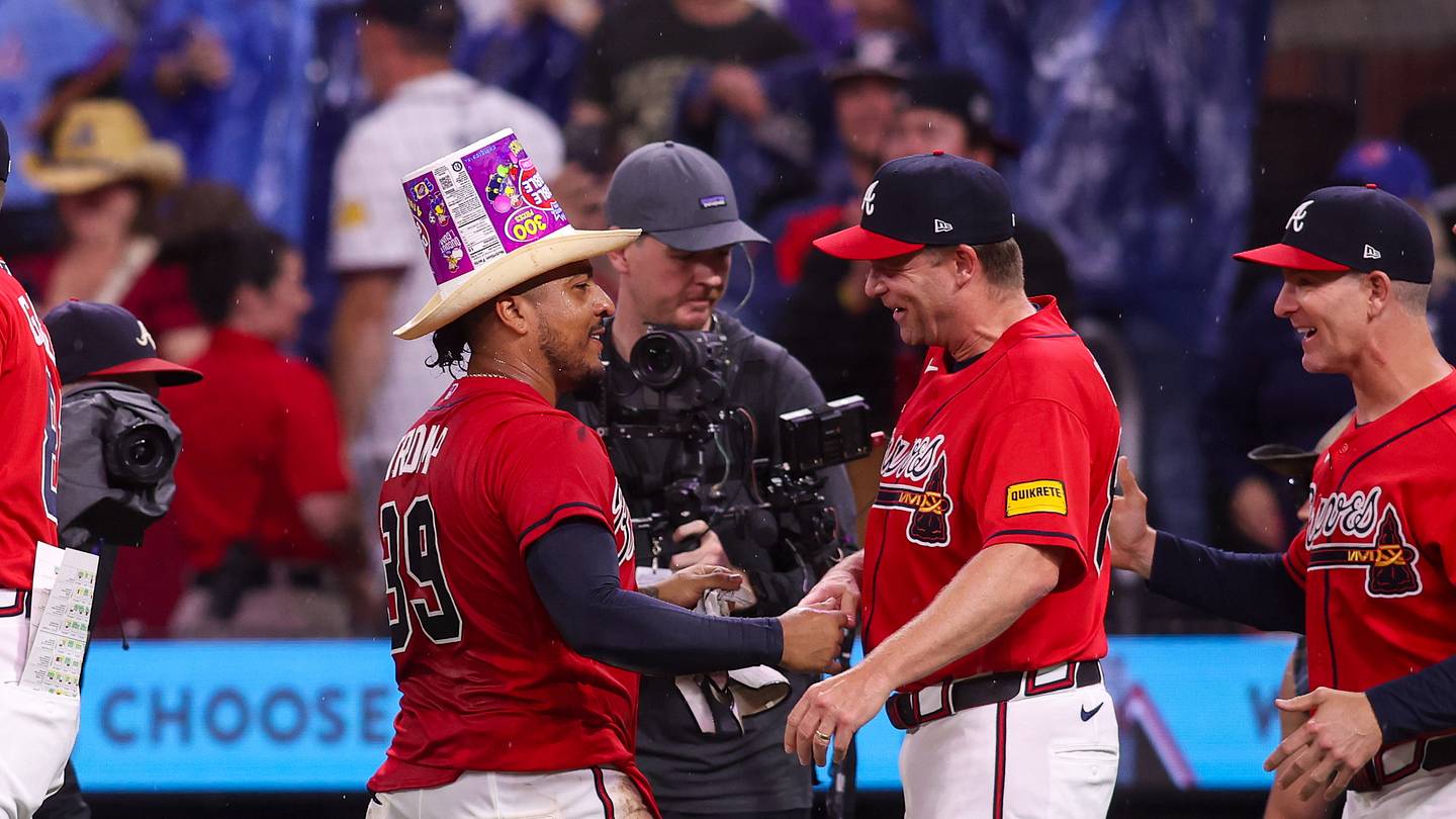 May 22, 2026; Atlanta, Georgia, USA; Atlanta Braves catcher Chadwick Tromp (39) celebrates with hitting coach Tim Hyers (80) after a walk-off single against the Washington Nationals in the eleventh inning at Truist Park. Mandatory Credit: Brett Davis-Imagn Images