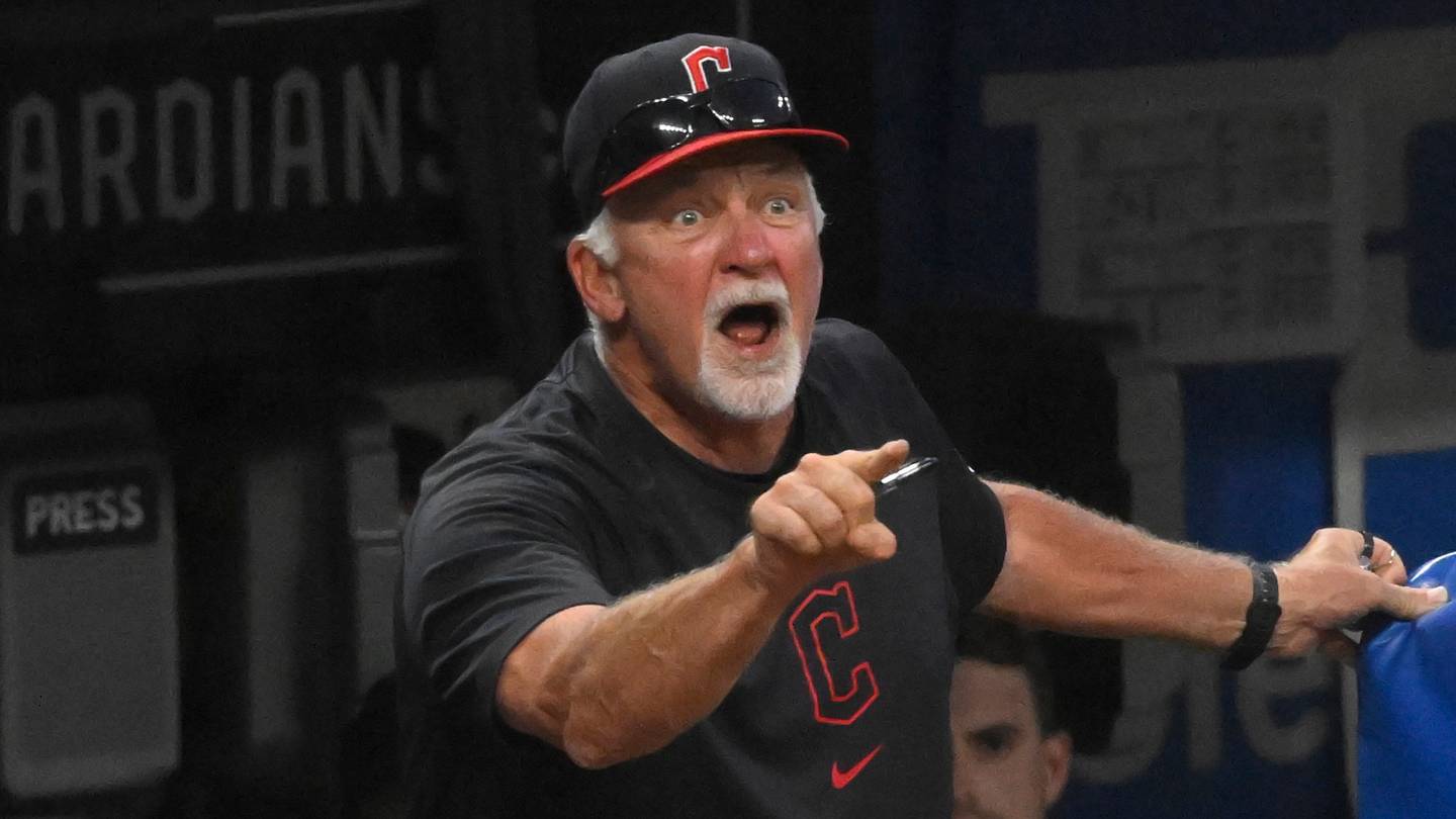Cleveland Guardians pitching coach Carl Willis (51) reacts