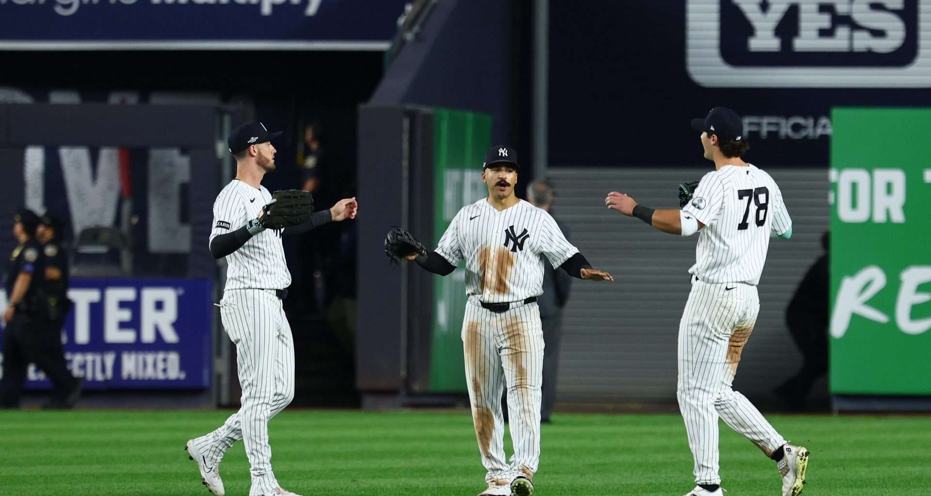 Sep 30, 2026; Bronx, New York, USA; New York Yankees outfielder Trent Grisham (12), outfielder Cody Bellinger (35) and catcher Austin Wells (28) celebrate after defeating the Boston Red Sox in game two of the Wildcard round for the 2026 MLB Playoffs at Yankee Stadium.
