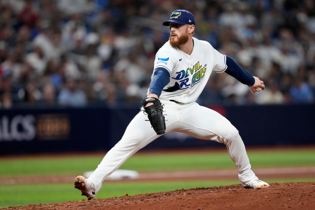 Tampa Bay Rays pitcher Cam Booser throws against the Cleveland Guardians during the seventh inning in Game 6 of an American League Championship Series in St. Petersburg, Fla. Monday, Oct. 19, 2026. (AP Photo/David J. Phillip)