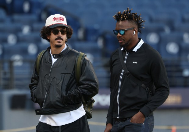 White Sox third baseman Miguel Vargas, left, and pitcher Huascar Brazobán arrive for Game 1 of the AL Division Series against the Guardians on Oct. 3 in Cleveland. (John J. Kim/Chicago Tribune)
