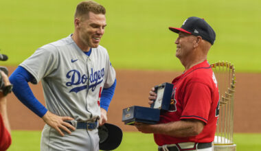 Jun 24, 2022; Cumberland, Georgia, USA; Los Angeles Dodgers first baseman Freddie Freeman (5) reacts as he receives his World Series ring from Atlanta Braves manager Brian Snitker (43) prior to the game at Truist Park. Mandatory Credit: Dale Zanine-USA TODAY Sports