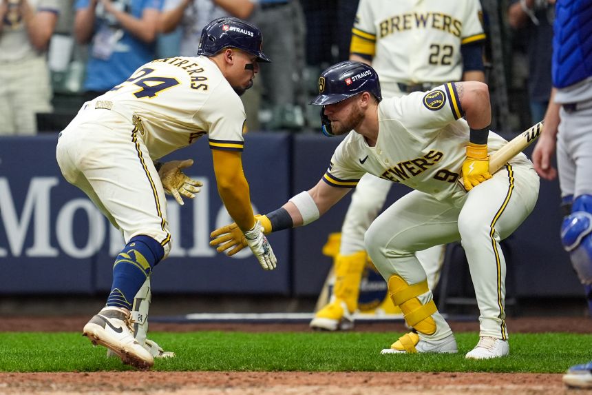 Milwaukee Brewers catcher William Contreras celebrates his Game 2 home run with teammate Jake Bauers on Monday.