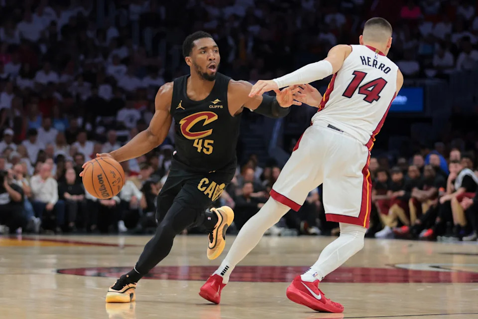 Cleveland Cavaliers guard Donovan Mitchell (45) dribbles the basketball as Miami Heat guard Tyler Herro (14) defends in the second quarter during game four for the first round of the 2025 NBA Playoffs at Kaseya Center. Mandatory Credit: Sam Navarro-Imagn Images