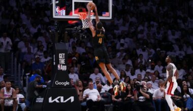 Evan Mobley of the Cleveland Cavaliers dunks the ball against Davion Mitchell in the Cavs