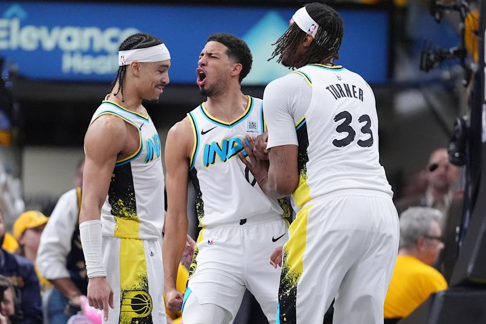 Indiana Pacers guard Tyrese Haliburton, center, celebrates a defensive play with teammates Andrew Nembhard, left, and center Myles Turner (33) during the second half in Game 5 of an NBA basketball first-round playoff series against the Indiana Pacers, in Indianapolis, Tuesday, April 29, 2025. (AP Photo/Michael Conroy)