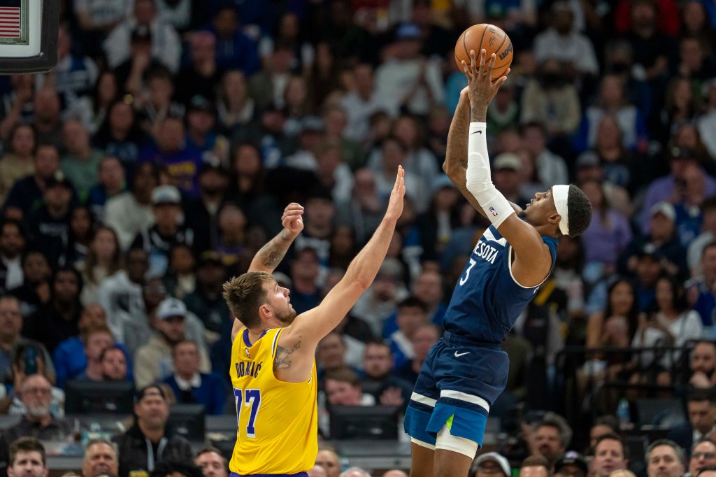 Minnesota Timberwolves forward Jaden McDaniels (3) shoots the ball over Los Angeles Lakers guard Luka Doncic (77) in the first half during game three of first round for the 2024 NBA Playoffs at Target Center.