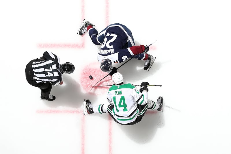 Jamie Benn of the Dallas Stars faces off with Nathan MacKinnon of the Colorado Avalanche