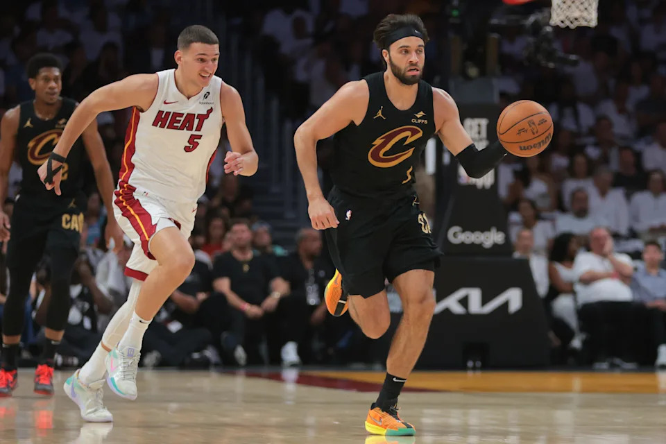Apr 28, 2025; Miami, Florida, USA; Cleveland Cavaliers guard Max Strus (1) dribbles the basketball past Miami Heat forward Nikola Jovic (5) in the second quarter during game four for the first round of the 2025 NBA Playoffs at Kaseya Center. Mandatory Credit: Sam Navarro-Imagn Images