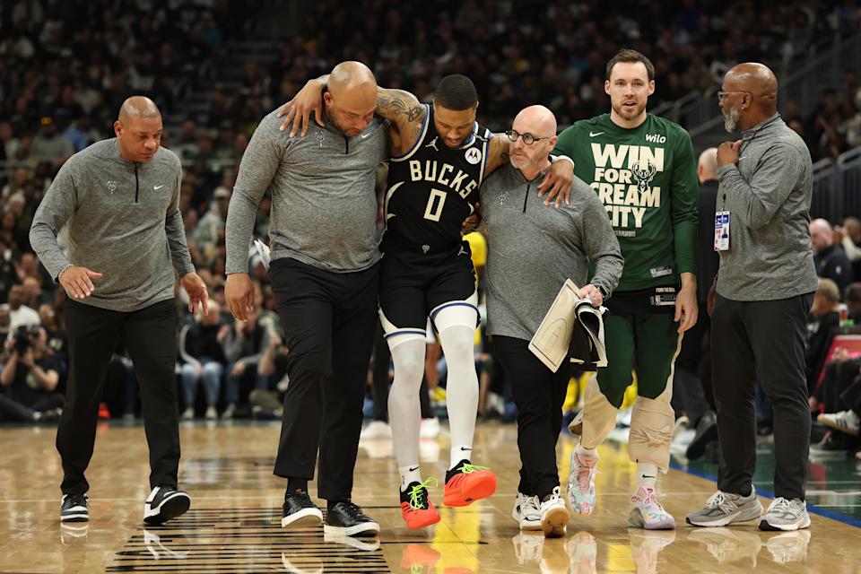 MILWAUKEE, WISCONSIN - APRIL 27: Damian Lillard #0 of the Milwaukee Bucks is helped off the court after an apparent injury during the first quarter in Game Four of the Eastern Conference First Round NBA Playoffs against the Indiana Pacers at Fiserv Forum on April 27, 2025 in Milwaukee, Wisconsin. NOTE TO USER: User expressly acknowledges and agrees that, by downloading and or using this photograph, User is consenting to the terms and conditions of the Getty Images License Agreement. (Photo by Stacy Revere/Getty Images)