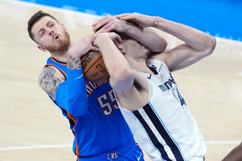 Oklahoma City Thunder center Isaiah Hartenstein (55) fights for the ball with Memphis Grizzlies center Zach Edey (14) during Game 2 of the NBA playoff series between the Oklahoma City Thunder and the Memphis Grizzlies at Paycom Center in Oklahoma City , Tuesday, April 22, 2025. Oklahoma City won 118-99.