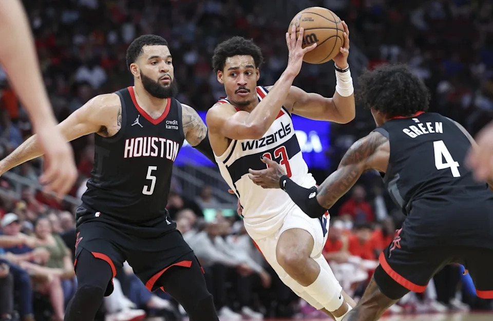 Washington Wizards guard Jordan Poole (13) drives with the ball as Houston Rockets guard Fred VanVleet (5) and guard Jalen Green (4) defend during the third quarter at Toyota Center.Troy Taormina-Imagn Images