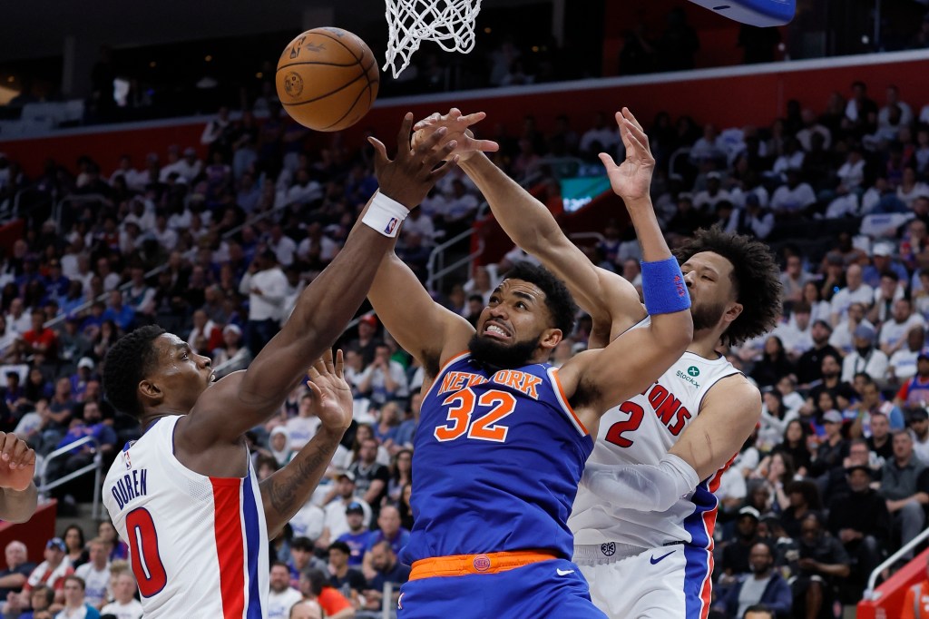 New York Knicks center Karl-Anthony Towns (32) has the ball knocked away by Detroit Pistons guard Cade Cunningham (2) and center Jalen Duren (0) during the first half of Game 3 of an NBA basketball first-round playoff series Thursday, April 24, 2025, in Detroit.