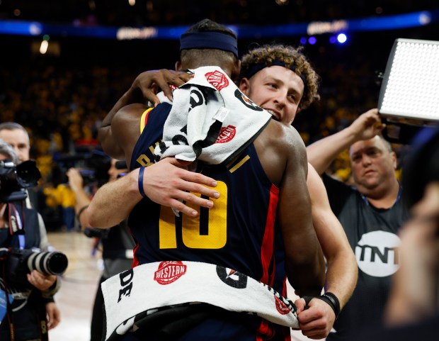 Golden State Warriors' Brandin Podziemski (2) hugs Golden State Warriors'...