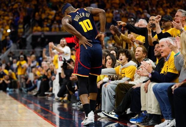 Golden State Warriors' Jimmy Butler III (10) holds his back...