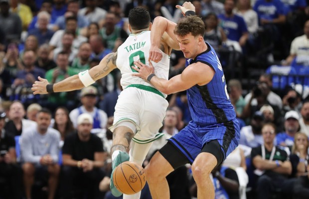 Orlando forward Franz Wagner (right) strips the ball from Boston...