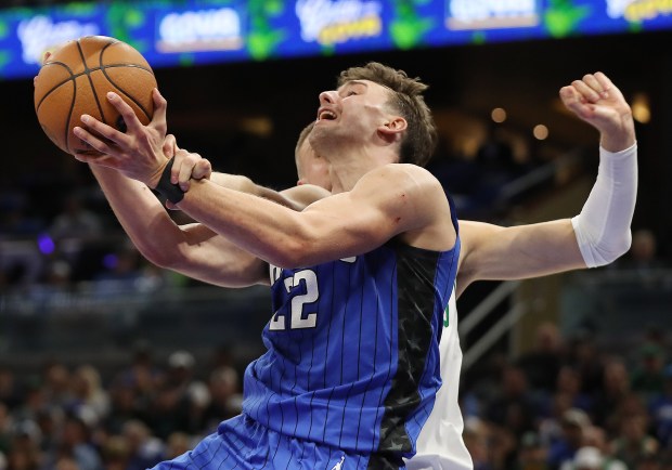 Orlando forward Franz Wagner (22) is fouled by Boston center...