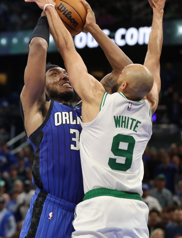 Orlando center Wendell Carter Jr. (left) tries to shoot through...